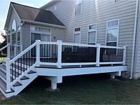 <b>Trex composite deck with stylized black aluminum balusters and a beveled-edge deck design</b>